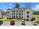 Attractive condo building with ample parking and green landscaping enhances the community's appeal at 493 White River Dr. # 28-D, Myrtle Beach, SC 29579