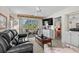 Inviting living room with a balcony view, comfortable seating, and a glimpse into the adjacent bedroom at 493 White River Dr. # 28-D, Myrtle Beach, SC 29579
