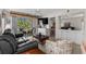 Cozy living room featuring comfortable seating, access to a balcony, and a partial view of the bedroom at 493 White River Dr. # 28-D, Myrtle Beach, SC 29579