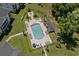 Aerial view of the community pool surrounded by ample lounge chairs and tropical landscaping at 493 White River Dr. # 28-D, Myrtle Beach, SC 29579
