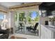 Inviting screened porch with comfortable seating and scenic views of the lush landscape and television at 493 White River Dr. # 28-D, Myrtle Beach, SC 29579
