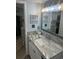 Bright bathroom featuring granite countertops and elegant lighting at 504 Ocean Blvd. N # 410, Myrtle Beach, SC 29577