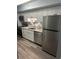 Charming kitchen features stainless steel appliances, granite counters, white cabinets and wood-look flooring at 504 Ocean Blvd. N # 410, Myrtle Beach, SC 29577