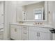 Bathroom featuring dual sinks, white cabinets and a decorative framed mirror at 512 9Th Ave. S, North Myrtle Beach, SC 29582