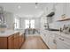 Bright kitchen featuring white cabinets, farmhouse sink, and stainless steel appliances at 512 9Th Ave. S, North Myrtle Beach, SC 29582