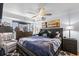 Cozy bedroom featuring a ceiling fan, king bed and bridge painting at 5511 N Ocean Blvd. # 902, Myrtle Beach, SC 29577