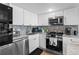 Bright kitchen with white cabinets, stainless steel appliances, and modern backsplash at 5511 N Ocean Blvd. # 902, Myrtle Beach, SC 29577