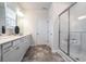 Beautiful bathroom equipped with a glass shower, white cabinets, double sinks and modern finishes at 640 Mccorkle Place, Conway, SC 29526