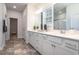 Elegant bathroom features double sinks, white cabinetry, a large mirror and modern fixtures at 640 Mccorkle Place, Conway, SC 29526