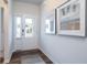 Bright foyer features a glass front door, hardwood floors, and modern artwork at 640 Mccorkle Place, Conway, SC 29526
