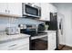 Bright kitchen with stainless steel appliances, granite countertops, and white cabinets at 640 Mccorkle Place, Conway, SC 29526
