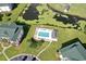 Aerial view of the community pool, waterway, and surrounding buildings and landscape at 697 Tupelo Ln. # 24G, Longs, SC 29568