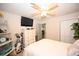 Comfortable bedroom featuring a flat-screen TV, ceiling fan, shelving, and a view into the hallway at 697 Tupelo Ln. # 24G, Longs, SC 29568