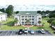 Aerial view of condo building with balconies, landscaping, and accessible parking at 697 Tupelo Ln. # 24G, Longs, SC 29568