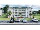 Inviting condominium building featuring multiple levels and well-maintained landscaping with ample parking at 697 Tupelo Ln. # 24G, Longs, SC 29568
