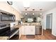 Modern kitchen with stainless appliances, granite countertops, and breakfast bar, open to a lovely living room at 697 Tupelo Ln. # 24G, Longs, SC 29568