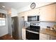 Updated kitchen featuring stainless steel appliances, granite countertops, and modern finishes at 697 Tupelo Ln. # 24G, Longs, SC 29568