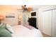 Spacious main bedroom features a ceiling fan, adjacent bathroom access, and a mounted television at 697 Tupelo Ln. # 24G, Longs, SC 29568
