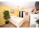 Bright main bedroom with light walls, a ceiling fan, and a decorative indoor tree to add a natural touch at 697 Tupelo Ln. # 24G, Longs, SC 29568