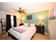 Comfortable main bedroom featuring a leaf-design ceiling fan, black nightstands, and coordinated wall decor at 697 Tupelo Ln. # 24G, Longs, SC 29568