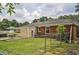 The backyard offers a patio with table set surrounded by mature trees at 728 Tarpon Ct., Myrtle Beach, SC 29579
