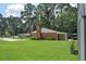 Green backyard features a patio with table set and barn-style storage shed at 728 Tarpon Ct., Myrtle Beach, SC 29579