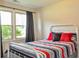 Bright bedroom with large windows and a stylish bed frame at 728 Tarpon Ct., Myrtle Beach, SC 29579