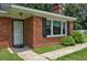 Close up of the front entrance of a brick home with a white door and black shutters at 728 Tarpon Ct., Myrtle Beach, SC 29579