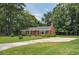 Cozy brick home with black shutters, a large driveway and a well-kept lawn at 728 Tarpon Ct., Myrtle Beach, SC 29579