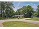 Picture of a brick home on a large lot with mature trees and long driveway at 728 Tarpon Ct., Myrtle Beach, SC 29579