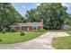 Charming brick home with mature trees, a long driveway, and spacious yard at 728 Tarpon Ct., Myrtle Beach, SC 29579