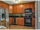 Spacious kitchen with stainless steel appliances, wood cabinets, and tile flooring at 728 Tarpon Ct., Myrtle Beach, SC 29579