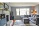 The living room features a large gray sofa, fireplace, and hardwood floors at 728 Tarpon Ct., Myrtle Beach, SC 29579