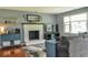 Cozy living room with a brick fireplace, TV, and hardwood floors at 728 Tarpon Ct., Myrtle Beach, SC 29579