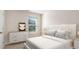 Cozy bedroom with neutral colors, a comfortable bed, and a window for natural light and street views at 7469 Meadow Walk Loop, Loris, SC 29569