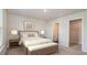 Serene bedroom with a large bed, soft lighting, and a view of the ensuite bathroom and closet at 7469 Meadow Walk Loop, Loris, SC 29569