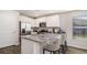 Modern kitchen with granite countertops, stainless steel appliances, and barstool seating at the island at 7469 Meadow Walk Loop, Loris, SC 29569