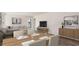 Inviting living and dining area with a table set for four, sleek furniture, and neutral decor at 7469 Meadow Walk Loop, Loris, SC 29569