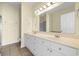 Bright bathroom with double sink vanity, white cabinetry, and large mirror over tile floor at 817 S Ocean Blvd. # 201, North Myrtle Beach, SC 29582