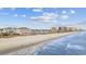 Beachfront condos and houses line the sandy shore, with ocean waves at 817 S Ocean Blvd. # 201, North Myrtle Beach, SC 29582