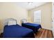 Cozy bedroom with two twin beds, wood floors, a window, and a light, airy ambiance at 817 S Ocean Blvd. # 201, North Myrtle Beach, SC 29582