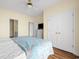 Airy bedroom featuring a ceiling fan, coastal decor, wood floors, and bright natural lighting at 817 S Ocean Blvd. # 201, North Myrtle Beach, SC 29582