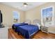 Comfortable bedroom with ceiling fan, wood floors and plenty of natural light at 817 S Ocean Blvd. # 201, North Myrtle Beach, SC 29582