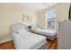 Bright bedroom with two twin beds, wood-look flooring, and a window for natural light at 817 S Ocean Blvd. # 201, North Myrtle Beach, SC 29582