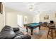 Spacious game room with a pool table, comfortable seating, and ceiling fans at 817 S Ocean Blvd. # 201, North Myrtle Beach, SC 29582