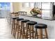 Granite kitchen island with bar stool seating and a beautiful ocean view visible from the window at 817 S Ocean Blvd. # 201, North Myrtle Beach, SC 29582