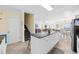 Kitchen with white cabinets, a granite countertop island, and stairs to the second floor at 817 S Ocean Blvd. # 201, North Myrtle Beach, SC 29582