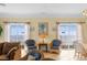 Charming living space featuring two large windows with ocean views and wicker furniture at 817 S Ocean Blvd. # 201, North Myrtle Beach, SC 29582