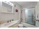 Bathroom features a tub with shower, decorative wall paper, and vanity with storage at 9501 Shore Dr. # B-224, Myrtle Beach, SC 29572