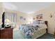 Bright bedroom features a floral comforter, a TV, and beach-themed decor at 9501 Shore Dr. # B-224, Myrtle Beach, SC 29572